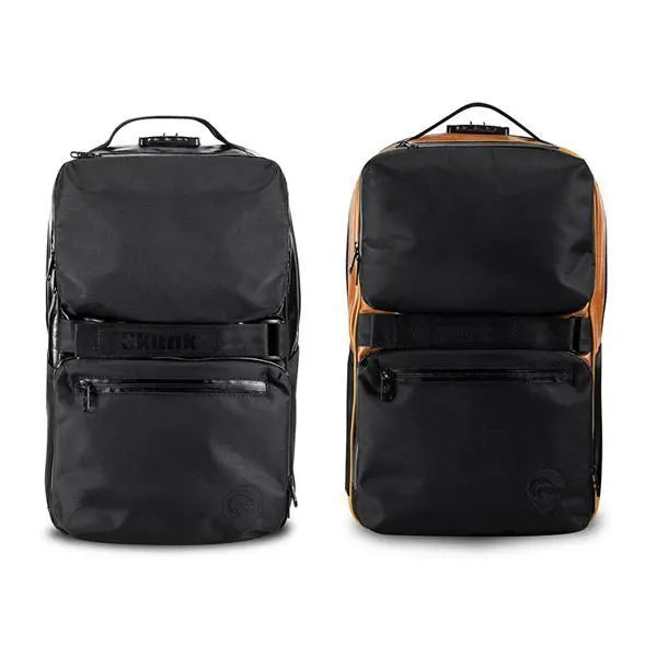 Two Skunk SoHo Smell Proof Backpacks are shown: one all black, the other black with orange sides. Both have front zippered pockets, top handles, a combo lock, and activated carbon lining for 100% odor-proof protection.
